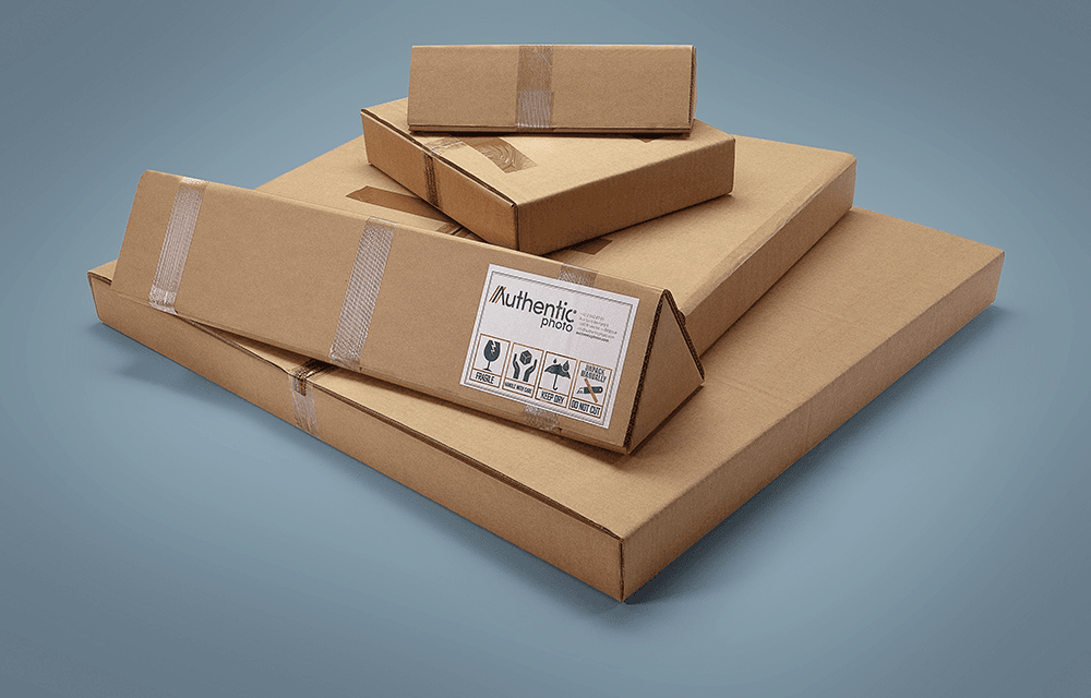 Stack of AuthenticPhoto branded cardboard shipping boxes in four different sizes