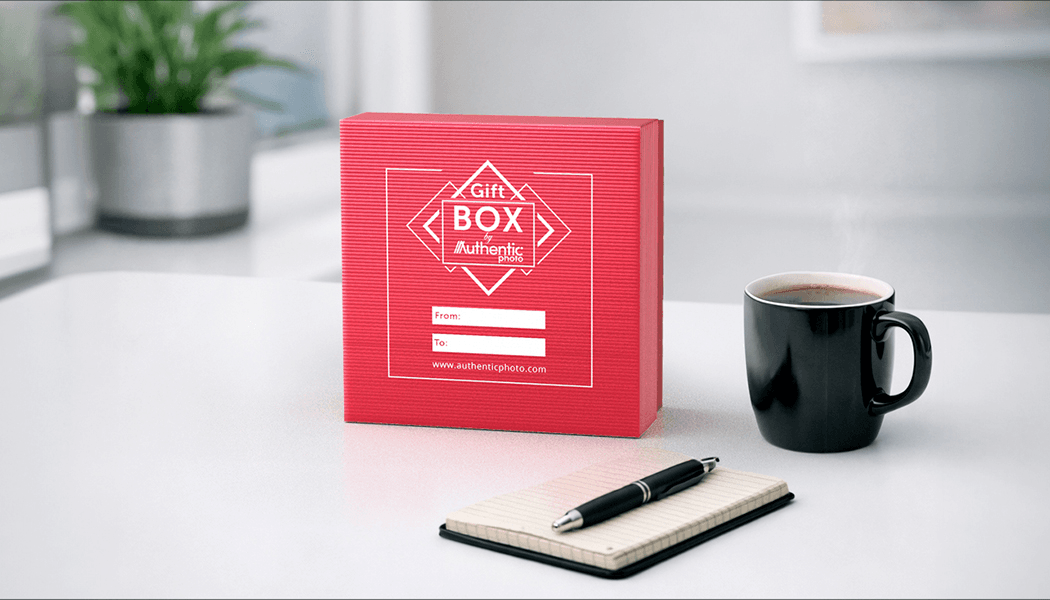 Red AuthenticPhoto gift box with From and To label on a desk with coffee and notepad