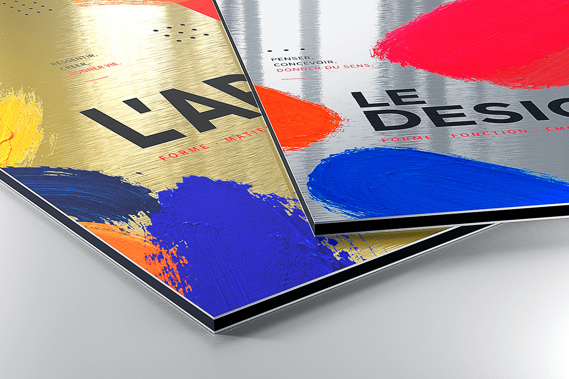 Two brushed dibond panels in gold and silver finishes with colorful paint stroke graphics, showing how the metallic texture shows through the print