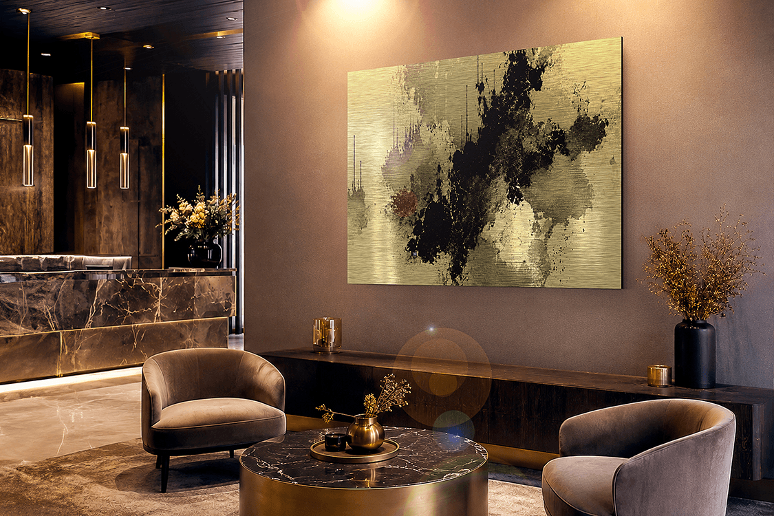 Abstract art on brushed gold dibond in a luxury hotel lobby with velvet armchairs, marble accents and warm ambient lighting
