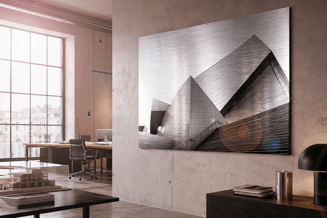 Large brushed silver dibond print of modern architecture in a contemporary office with concrete walls and natural light