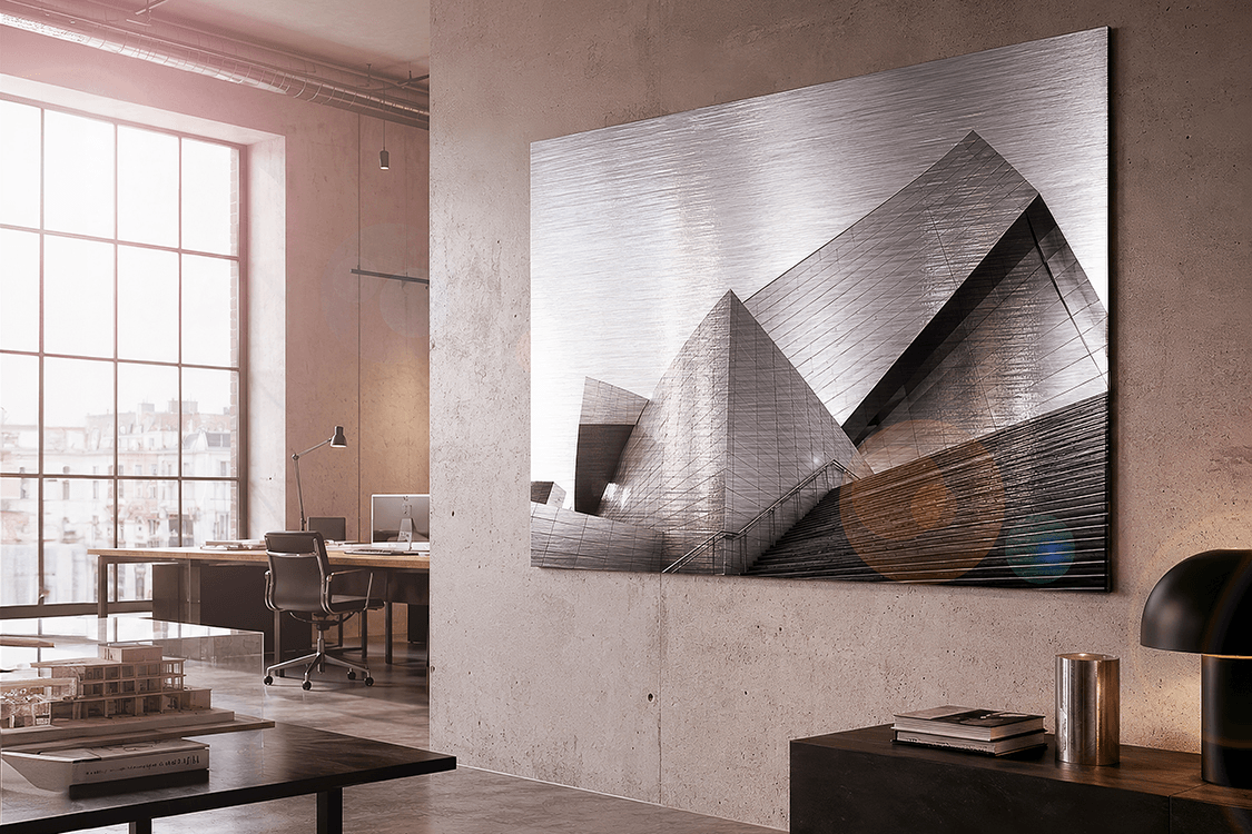 Large brushed silver dibond print of modern architecture in a contemporary office with concrete walls and natural light