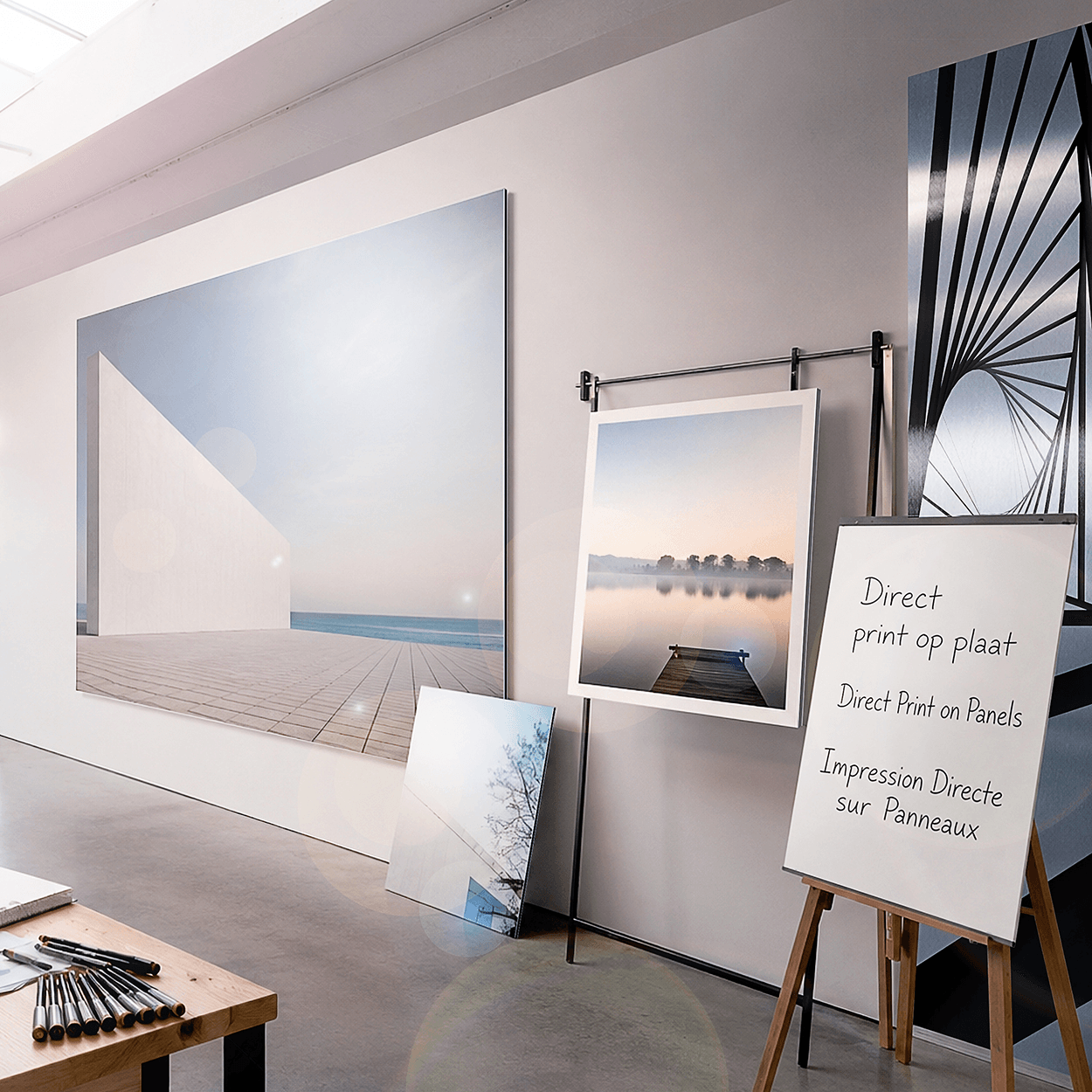Showroom display of direct panel prints featuring landscape and architectural photos on various rigid substrates