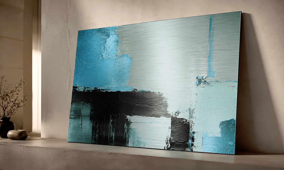 Abstract art in teal and black on brushed silver dibond, displayed in a minimalist interior with natural light