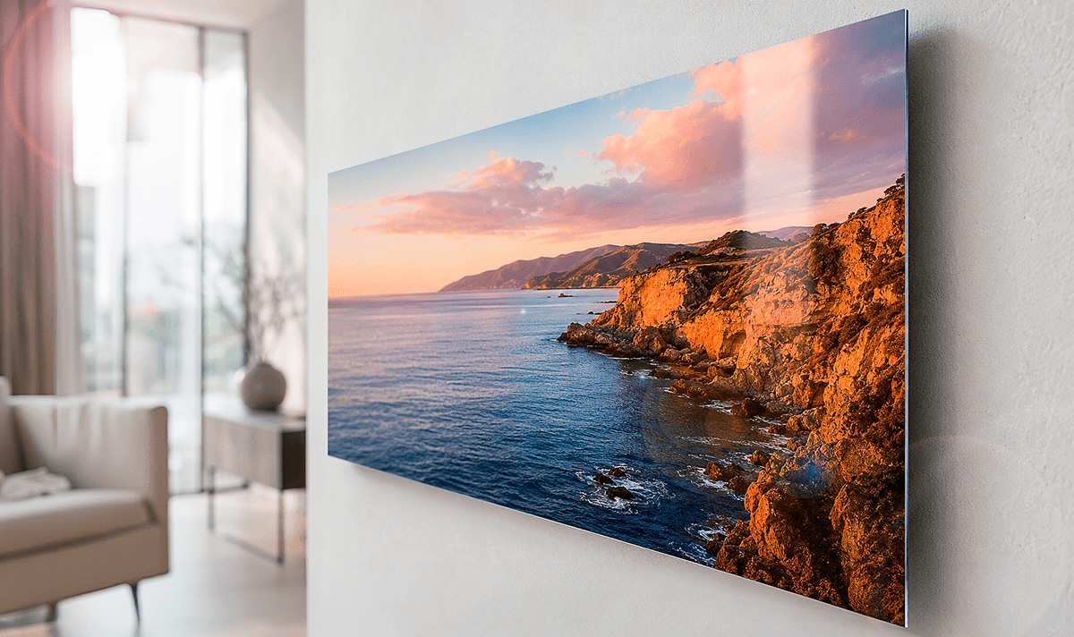 ChromaLuxe metal print of a coastal sunset with rocky cliffs, displayed without glass for a reflection-free viewing experience