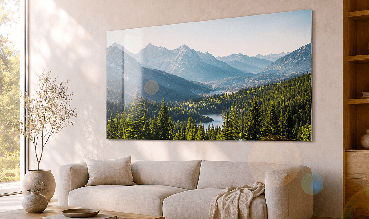 ChromaLuxe metal print of an alpine mountain landscape with pine forest and lake, hung above a sofa in a minimalist living room