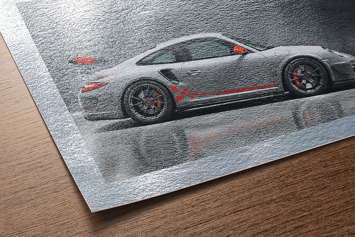Hahnemühle Photo Rag Metallic fine art paper swatch with silver-toned glossy surface and dynamic light reflections