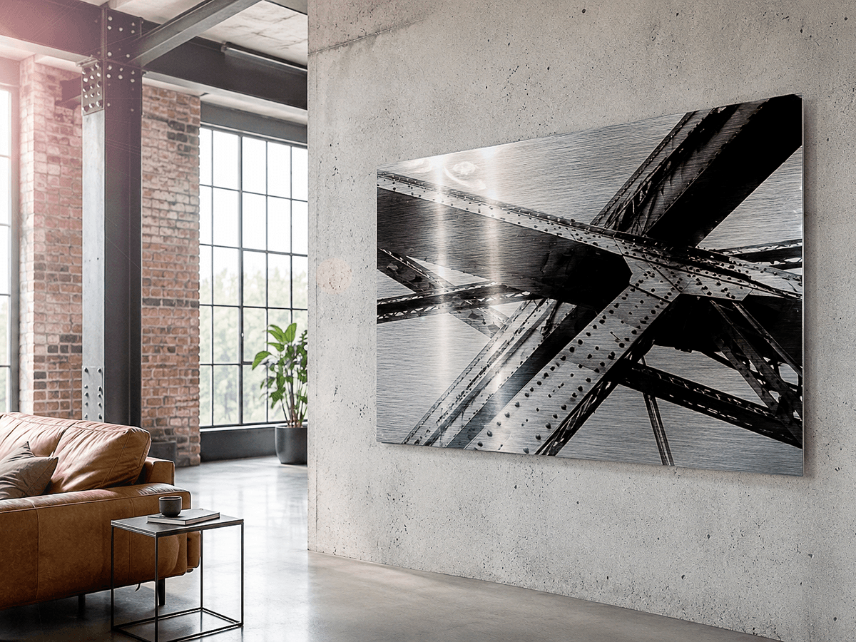 ChromaLuxe Brushed print of steel bridge structure on concrete wall in industrial loft with brick and leather sofa