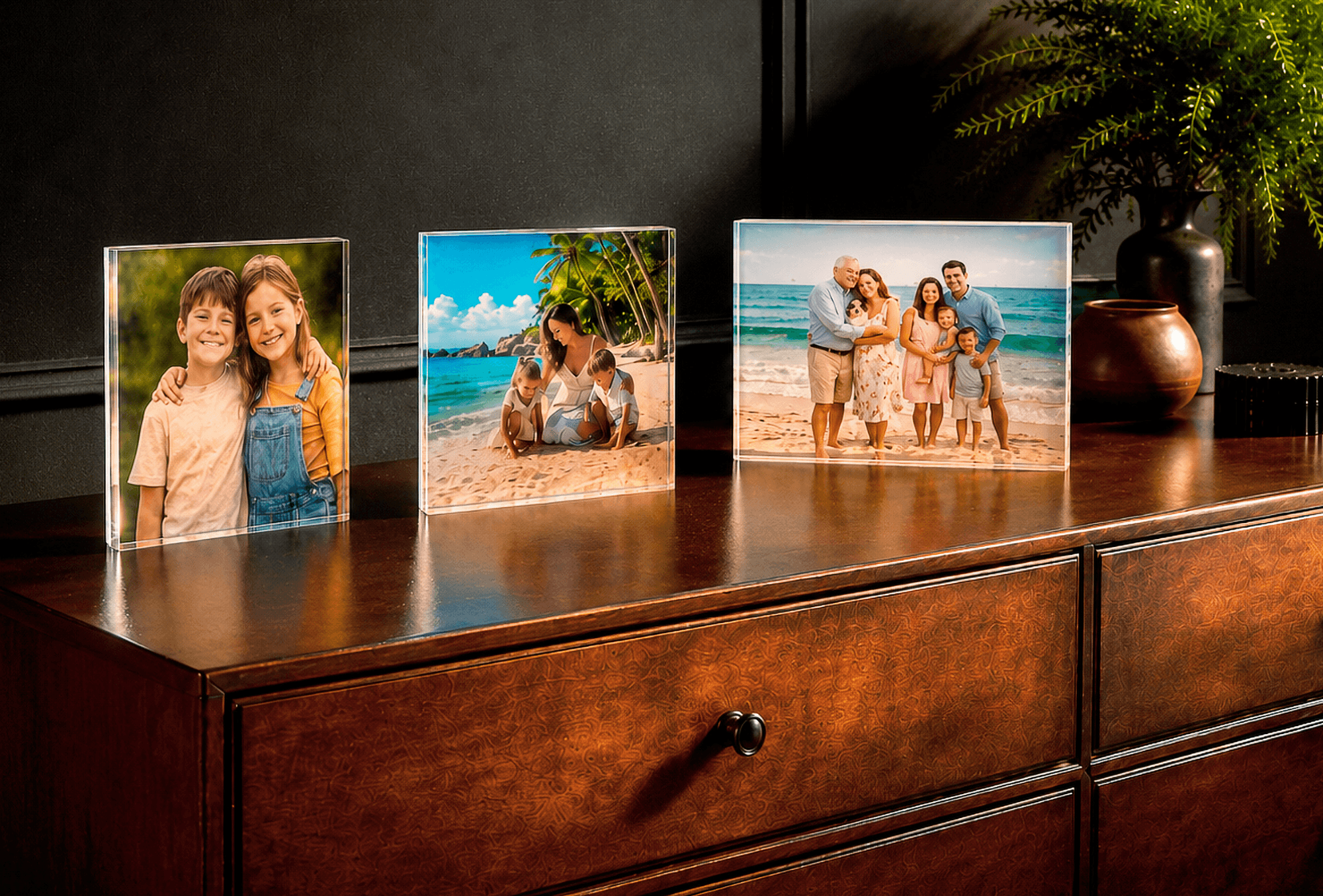 Three Acrylux Block photo prints on wooden sideboard showing family portraits and beach vacation memories