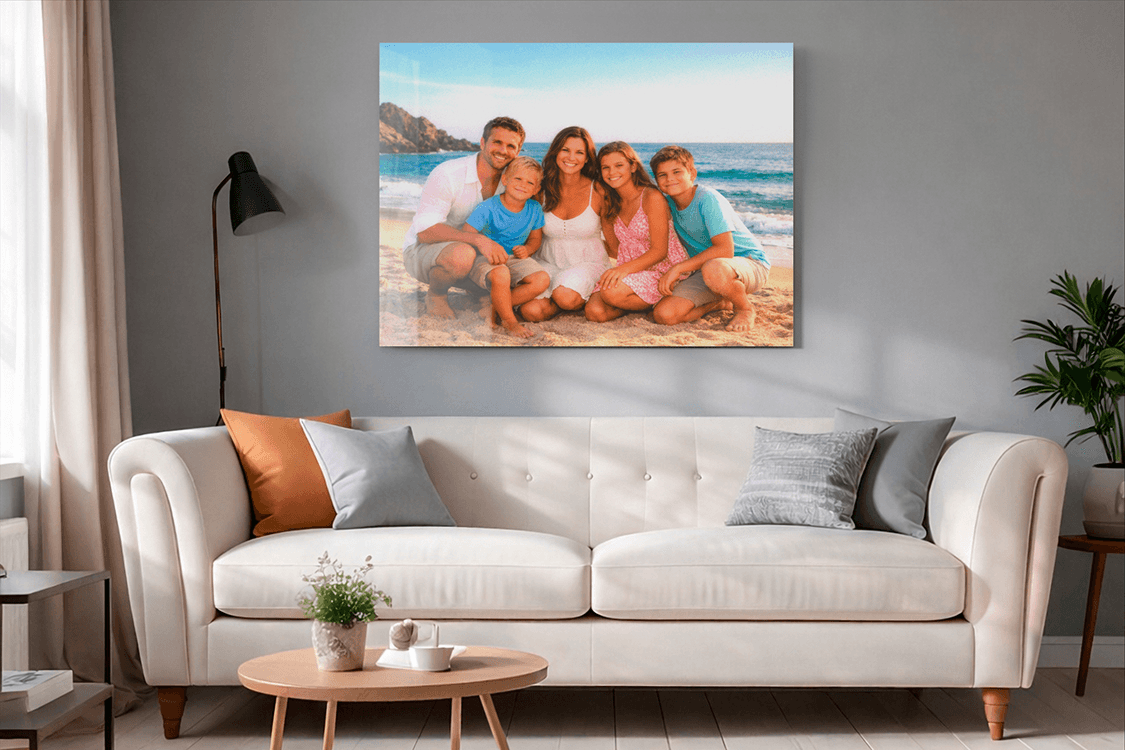 Family beach photo behind plexiglass above a white sofa in a modern living room