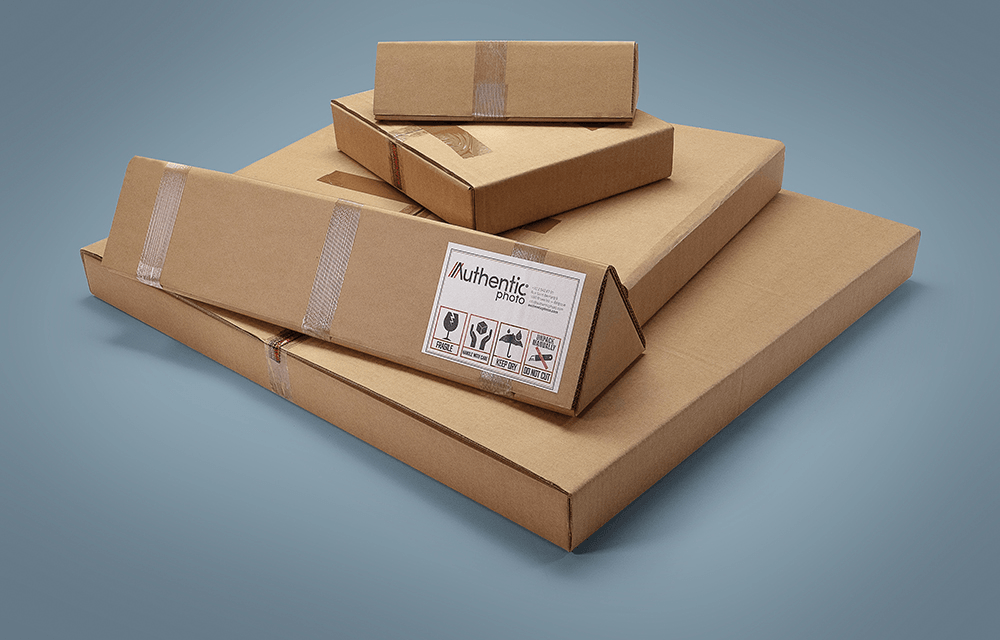 Stack of AuthenticPhoto branded cardboard shipping boxes in four different sizes