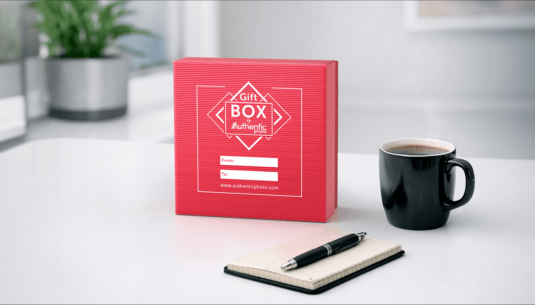 Red AuthenticPhoto gift box with From and To label on a desk with coffee and notepad