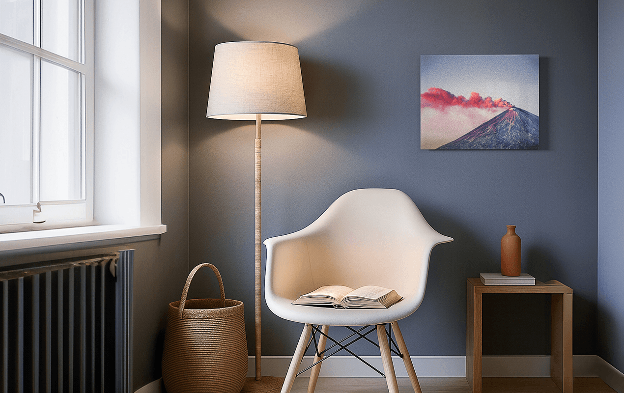 Small volcano photo print displayed on a wall in a cozy reading corner with chair and lamp