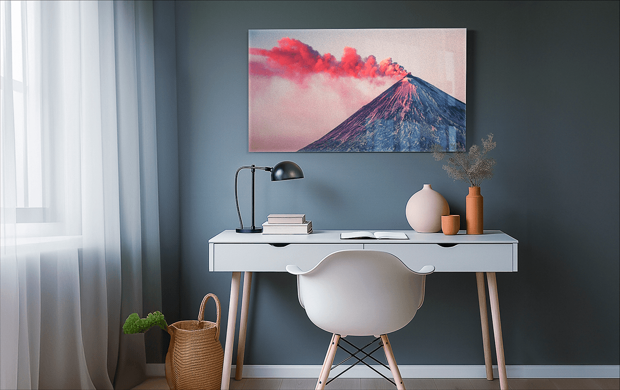 Medium-sized volcano photo print hanging above a modern desk in a home office setting