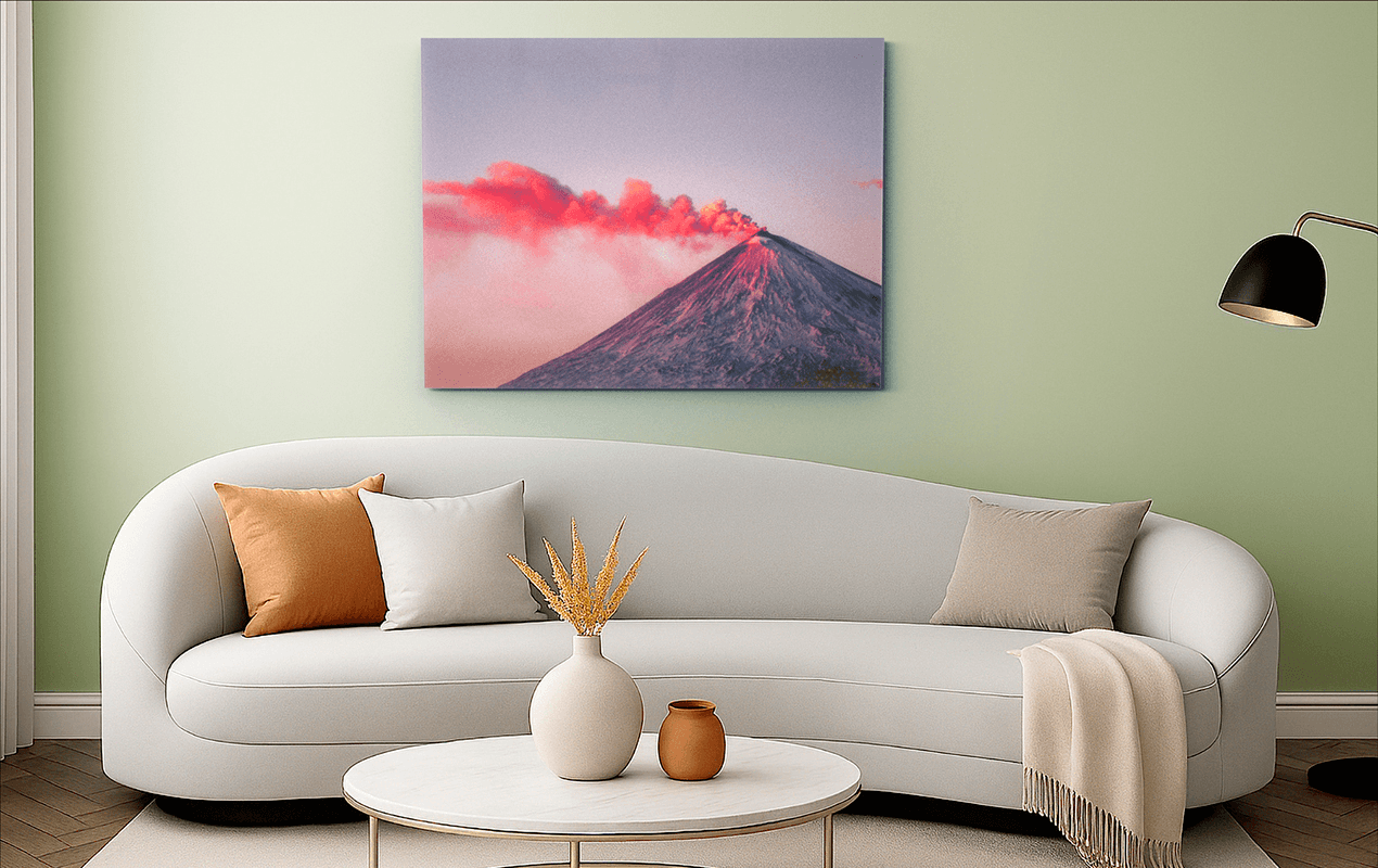 Large volcano photo print mounted above a sofa in a stylish green living room