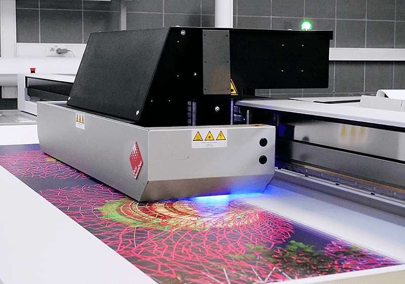 Industrial UV flatbed printer curing a vivid colour image directly onto a rigid panel