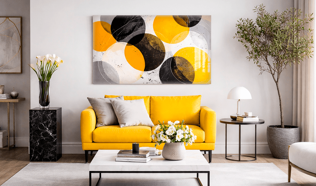 Abstract art print behind plexiglass above a yellow sofa in a stylish living room