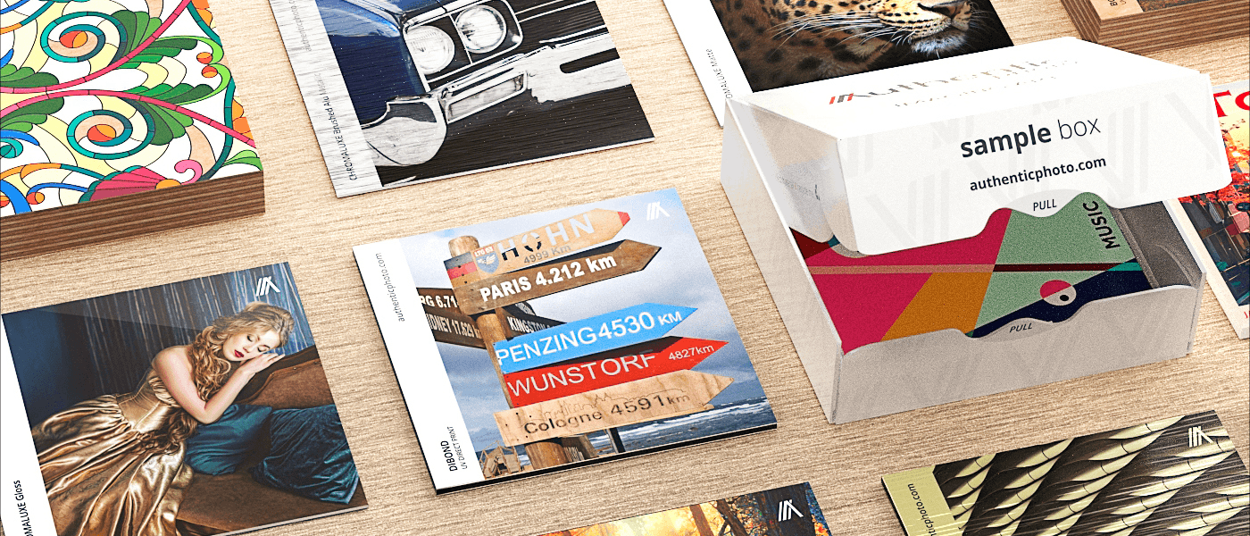 Photo plate print sample set with branded box and vibrant plate samples on a wooden surface